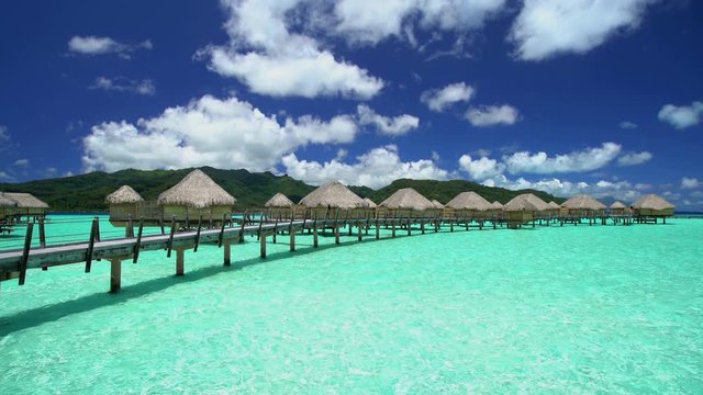 Overwater luxury Bungalows in tropical Aquamarine lagoon a Tahitian vacation resort of Bora Bora Island in the South Pacific French Polynesia