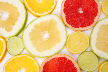 Fototapeta na wymiar cut pieces of different citrus fruits