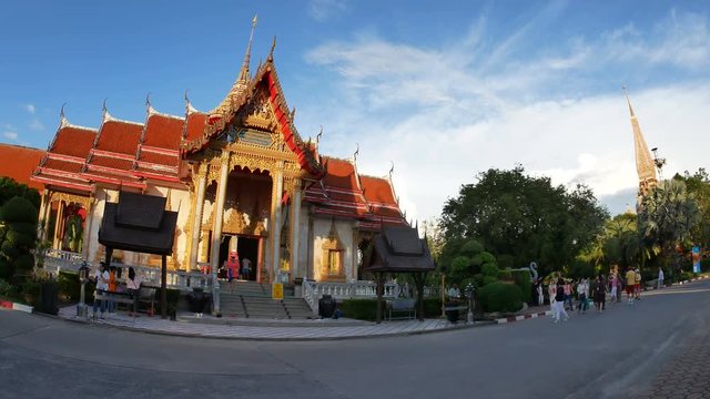 Phuket, Thailand- 28 November 2018 -  Thai buddhist church and big high relics pagoda at Chalong temple or Wat Chaithararam, famous tourism attraction sightseeing,  with cloudy blue sky and green tree