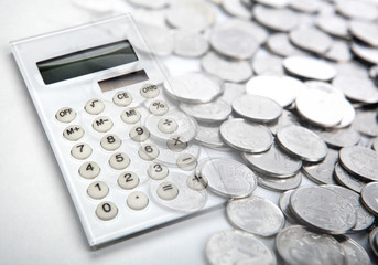 white calculator with russian ruble coins close up