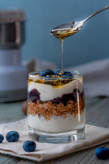 Yogurt, granola and honey, healthy breakfast.