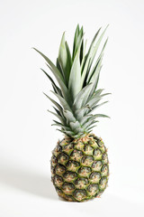 Pineapple on a white background. Close-up. Vertical frame orientation.
