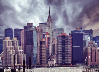 Manhattan skyline on a cloudy day, vintage color toning applied, New York City, USA.