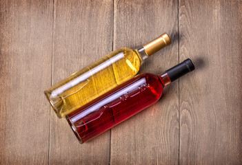 two wine bottles on wooden table