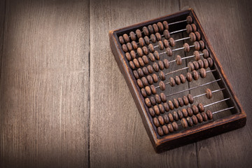 Accounting abacus on wooden textured background