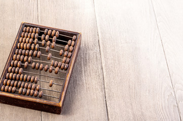 Accounting abacus on wooden textured background