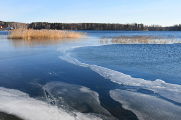 Thin ice on the lake Uvildy in late autumn in clear weather, Chelyabinsk region. Russia