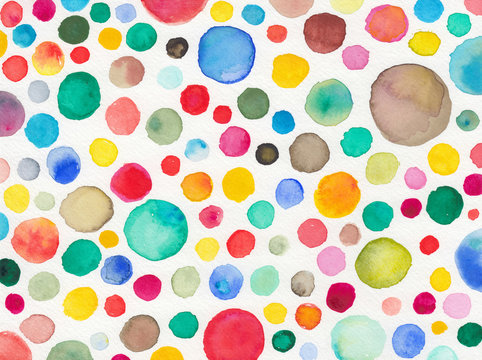 abstract watercolor background painting, fun hand painted circles in colorful daubs of blue red green yellow orange and pink on white watercolor paper texture