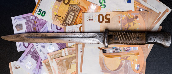 The concept of money is to share, euro money notes with a knife. Business, crime.