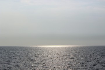 sun hiding in sea, reflection of sun