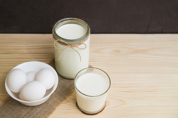 milk and eggs on a wooden table, farm natural products