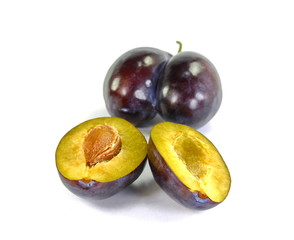  Plums cut in half isolated on white background