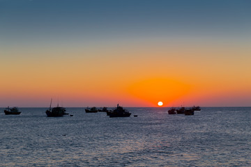 Naklejka na ściany i meble Vietnam Mui Ne village fishing boats and ships in sunset light