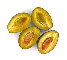  Plums cut in half isolated on white background