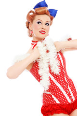 Young beautiful happy pin-up girl in red corset over white background