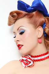 Profile portrait of young beautiful pin-up girl with fancy blue make-up