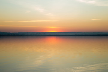 Fototapeta na wymiar Beautiful red sunset over lake. Composition of nature.