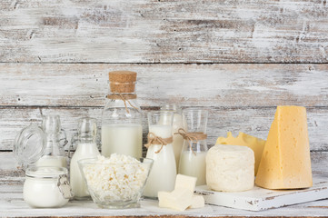 Fermented milk products: milk, kefir, sour cream, cottage cheese, butter, cheese on a white wooden table