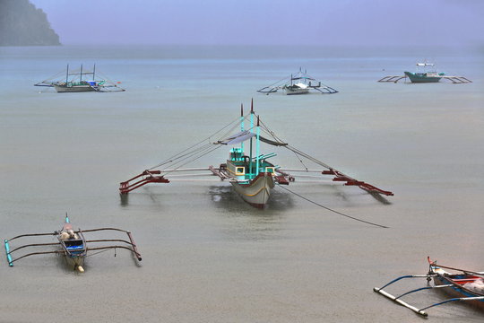 Fishing and tour boats stranded-moored under heavy rain. El Nido-Palawan-Philippines-0817