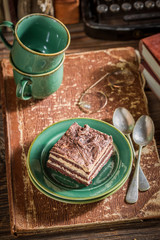 Closeup of tasty cake and coffee with old books