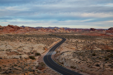 Fototapeta na wymiar Aerial view on the scenic road in the desert during a cloudy sunrise. Taken in Valley of Fire State Park, Nevada, United States.