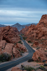Aerial view on the scenic road in the desert during a cloudy sunrise. Taken in Valley of Fire State Park, Nevada, United States.