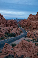 Aerial view on the scenic road in the desert during a cloudy sunrise. Taken in Valley of Fire State Park, Nevada, United States.