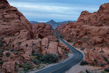 Aerial view on the scenic road in the desert during a cloudy sunrise. Taken in Valley of Fire State Park, Nevada, United States.