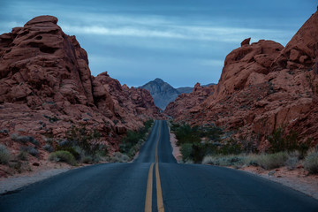 Scenic view on the road in the desert during a cloudy sunrise. Taken in Valley of Fire State Park, Nevada, United States.