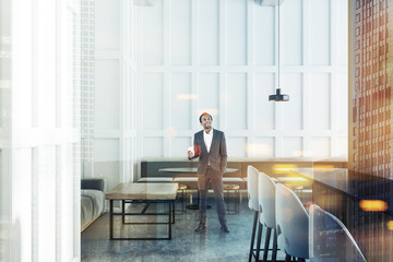 White bar interior with sofas, man