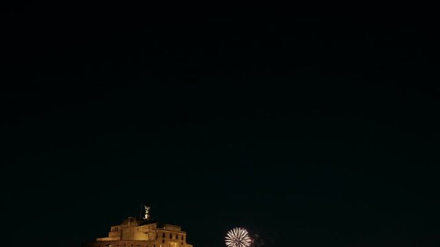 Camera Tilt Down From Dark Sky To Reveal Riverfront View Of Fireworks, Castel Sant'Angelo And Bridge Reflections Lighted At Night In Rome, Italy. 4K UHD At 25fps