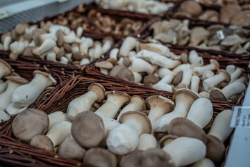 fresh mushrooms on sale in a wicker basket