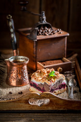 Closeup of tasty cherry pie with pot boiled coffee