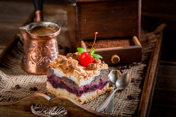 Closeup of cherry pie and boiled coffee on wooden tray