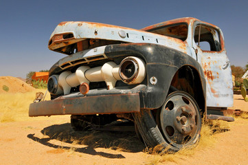 Old and rusty car wreck at the last gas station before the Namib desert. Solitaire, Namibia.