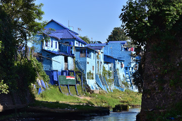 Fototapeta na wymiar Panoramic view of village with old houses and rooftops painted in blue color in village Kampung Biru Arema, Malang City, Central Asia, Indonesia