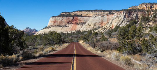 Panoramic view of a scenic road in the Canyons during a sunny summer day. Taken in Zion National Park, Utah, United States.