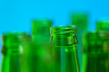 Seven green bottlenecks on blue background