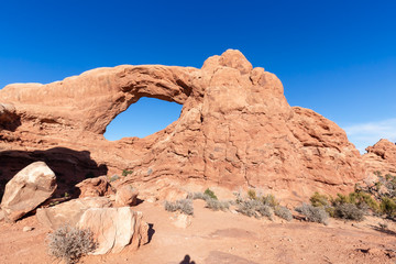 Fototapeta na wymiar Scenic landscape of an Arch rock formation during a vibrant sunny day. Taken in Arches National Park, located near Moab, Utah, United States.