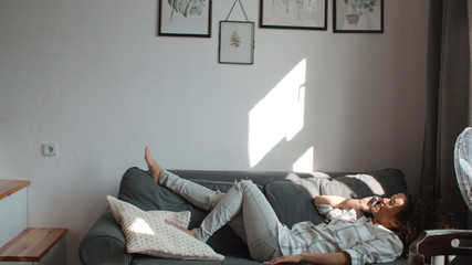 Young woman using mobile phone at home.