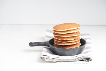 Pancake Breakfast with chocolate paste, nuts and berries. White background.