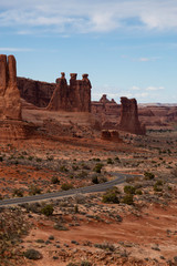 Fototapeta na wymiar Panoramic landscape view of a Scenic road in the red rock canyons during a vibrant sunny day. Taken in Arches National Park, located near Moab, Utah, United States.