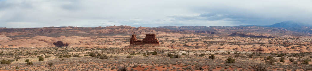 Panoramic landscape view of beautiful red rock canyon formations during a vibrant sunny day. Taken in Arches National Park, located near Moab, Utah, United States.