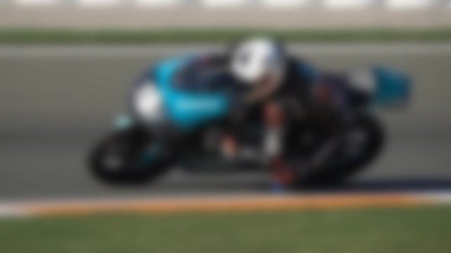 Racing circuit blurred motorcycle in curve and slow-mo