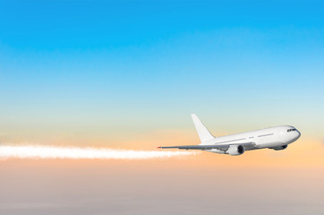 Passenger airplane flying at flight level high in the sky sunrise.
