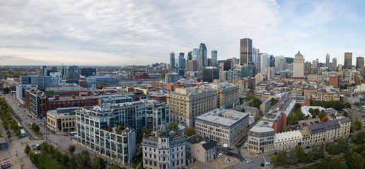 Aerial panoramic view of a modern cityscape during a vibrant day during fall season. Taken in Montreal, Quebec, Canada.