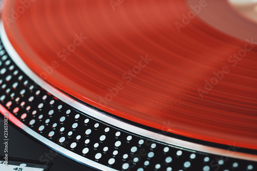 Vinyl Record Closeup A Ray Of Light On A Piece Of Vinyl Turntable Player Sound Technology For Dj To Mix And Play Music Red Vinyl The Texture Of The Bands On The