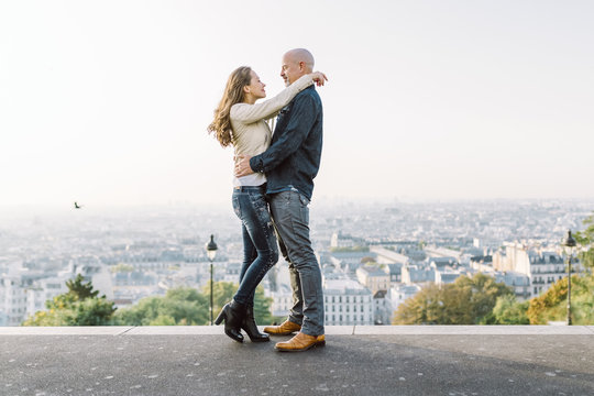 Couple in Montmartre with panoramic view of Paris