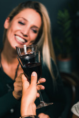 Drinking Red Wine. Young Women Toasting With Red Wine