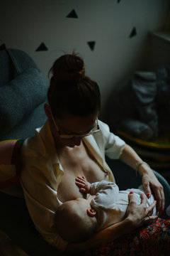 Young mother breastfeeding her baby